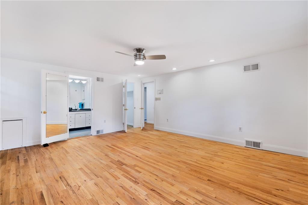 199 Farmington Road Pittsburgh, PA 15215 - Photo 22 of 46 a view of a room with wooden floor and ceiling fan