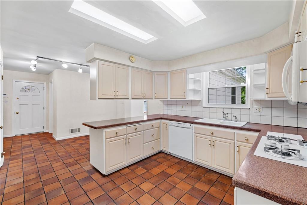 199 Farmington Road Pittsburgh, PA 15215 - Photo 9 of 46 a kitchen with stainless steel appliances granite countertop a sink stove and cabinets