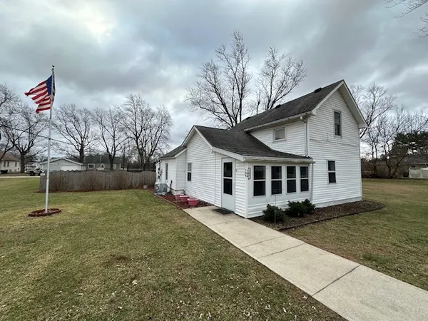 a house that has a tree in front of it