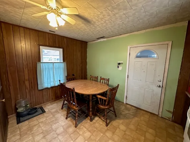a dining room with furniture and window