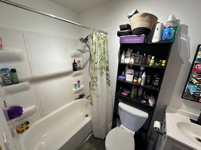 a bathroom with a bathtub toilet and a shower