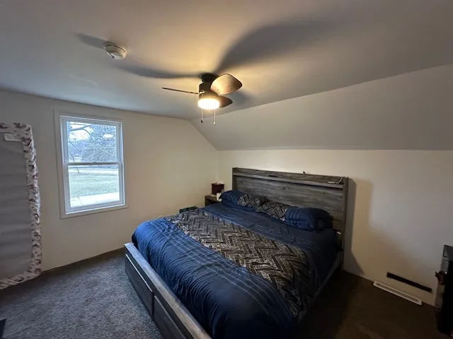 a bed sitting in a room next to a window