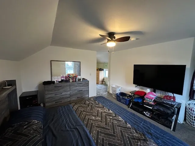 a bed room with furniture and a flat screen tv