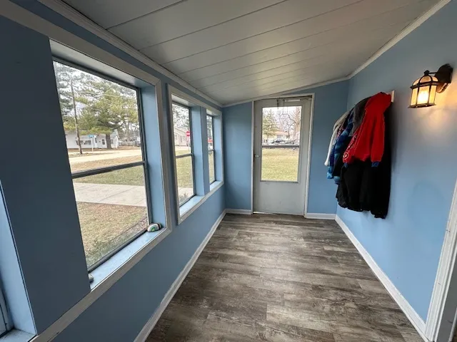 a view of hallway with wooden floor and balcony