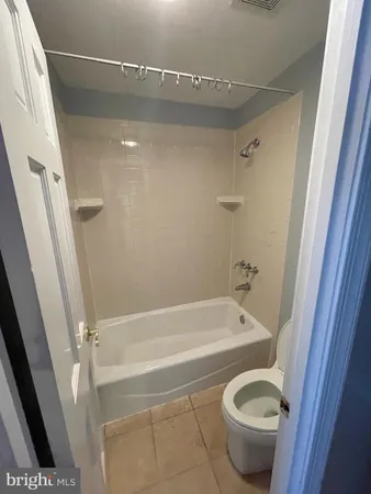a bathroom with a tub and toilet
