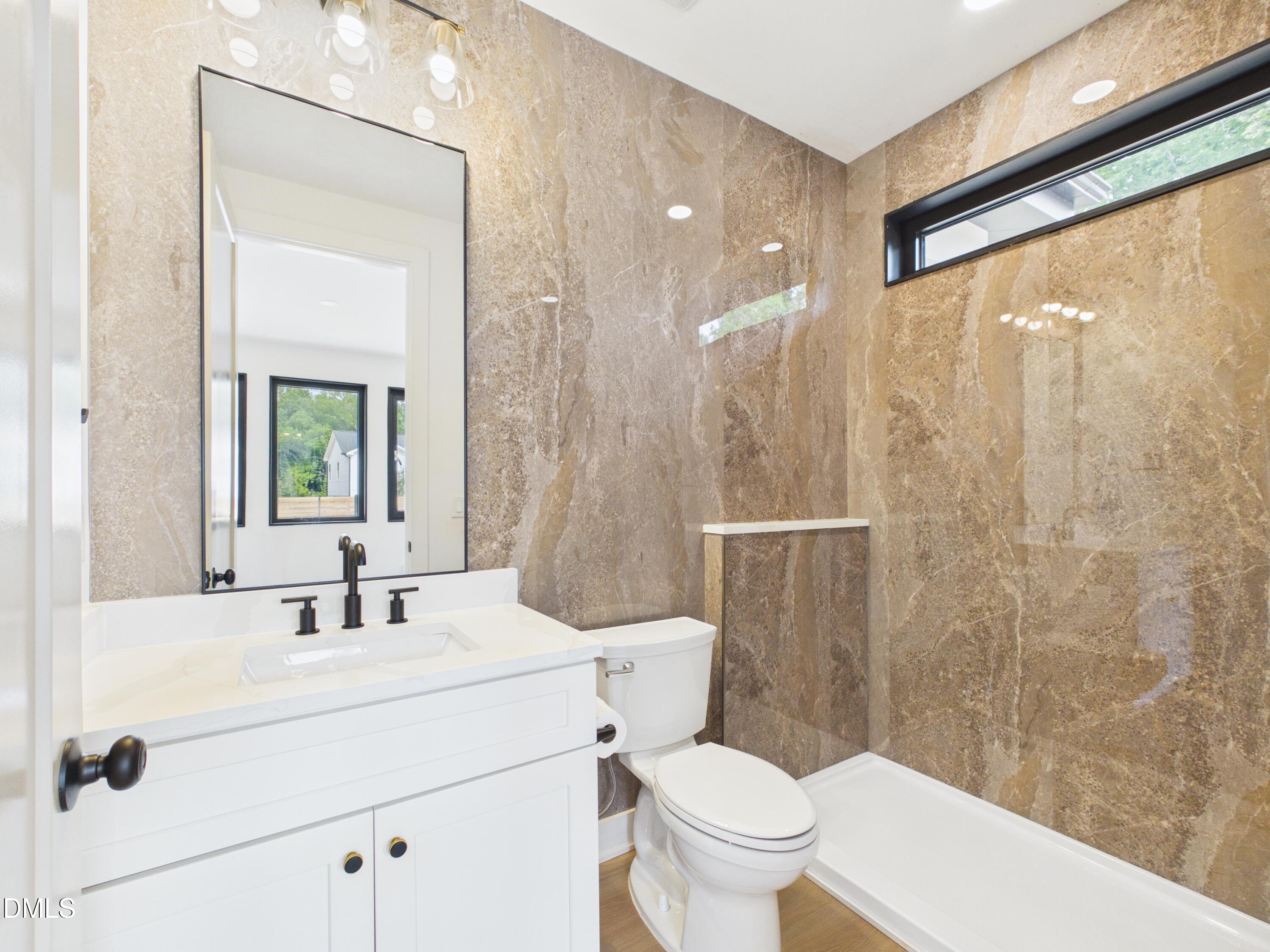 6925 Buckhorn-Duncan Road Holly Springs, NC 27540 - Photo 14 of 43 a bathroom with a sink a toilet and shower