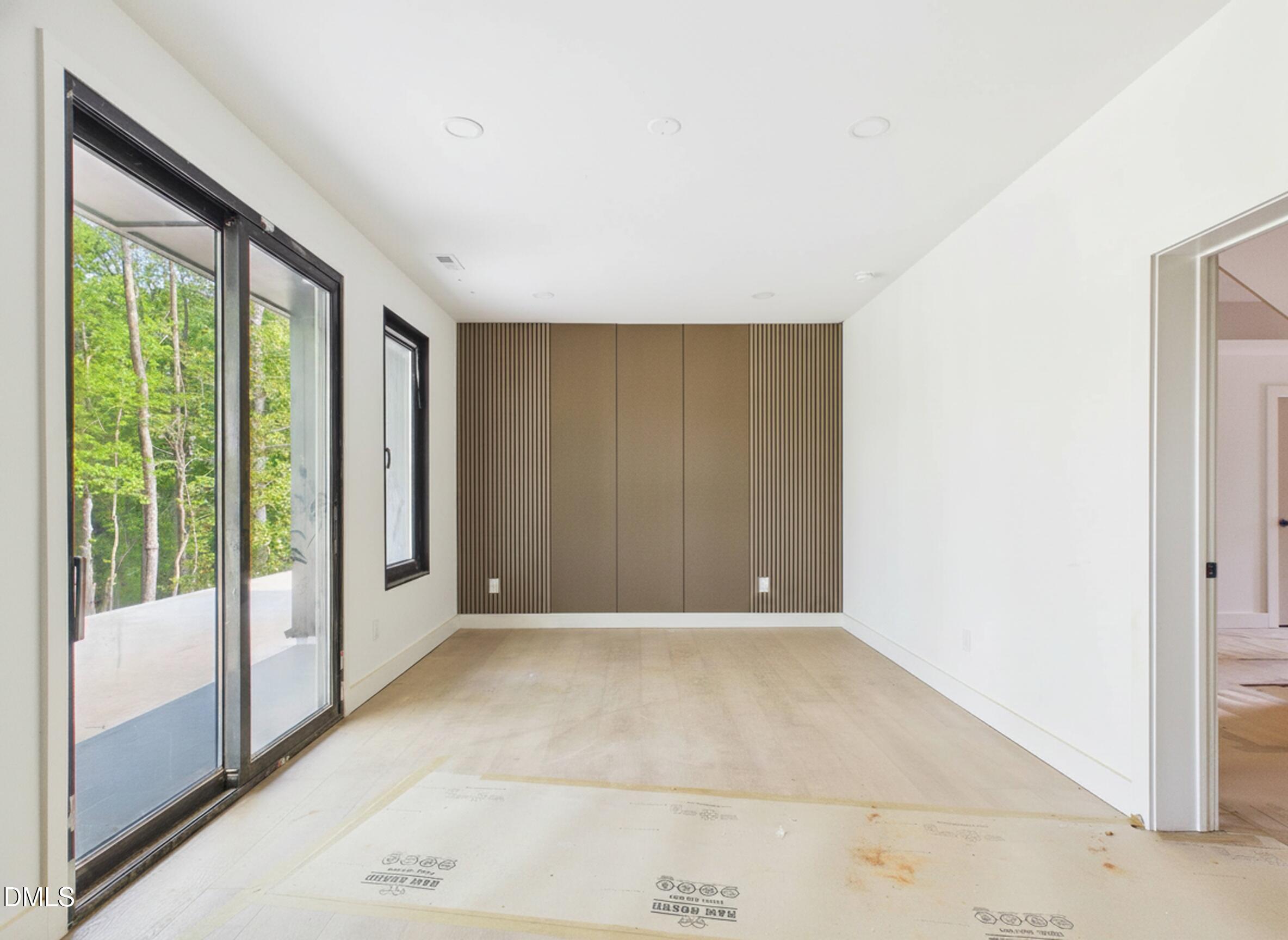 6925 Buckhorn-Duncan Road Holly Springs, NC 27540 - Photo 17 of 43 a view of an empty room with glass door
