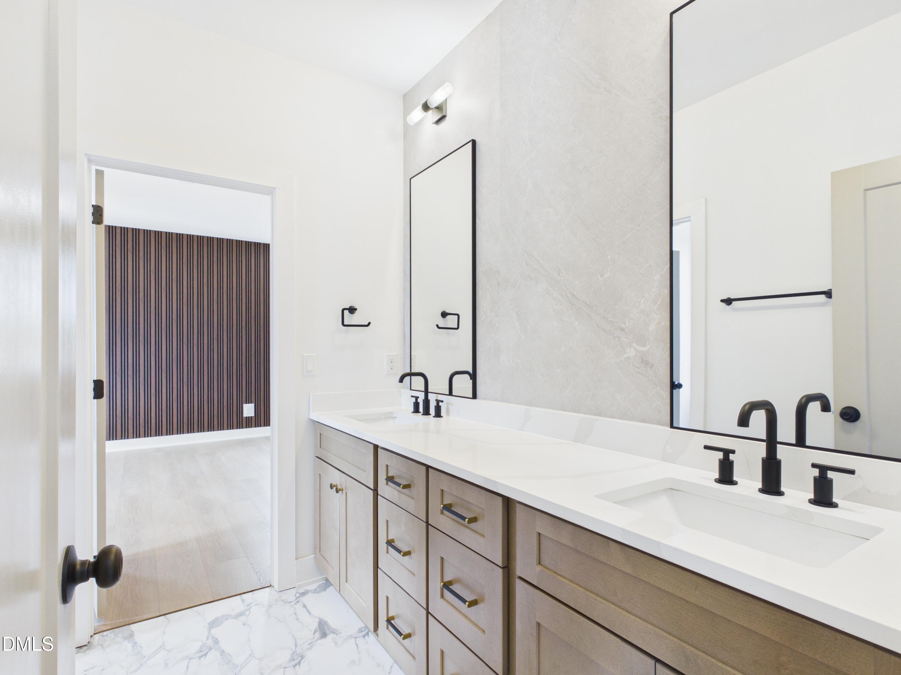 6925 Buckhorn-Duncan Road Holly Springs, NC 27540 - Photo 27 of 43 a bathroom with a double vanity sink and a mirror