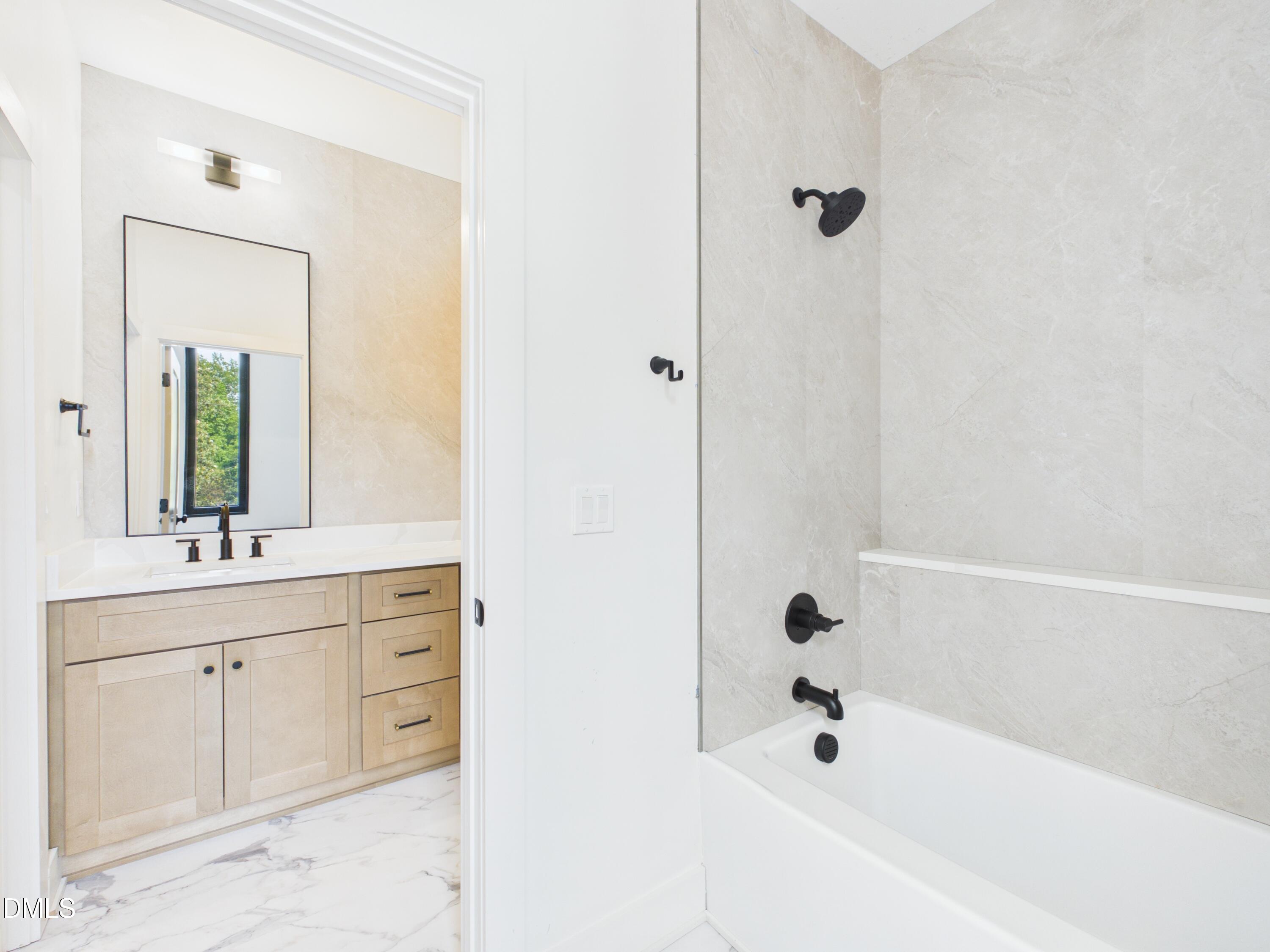 6925 Buckhorn-Duncan Road Holly Springs, NC 27540 - Photo 29 of 43 a bathroom with a tub sink and mirror
