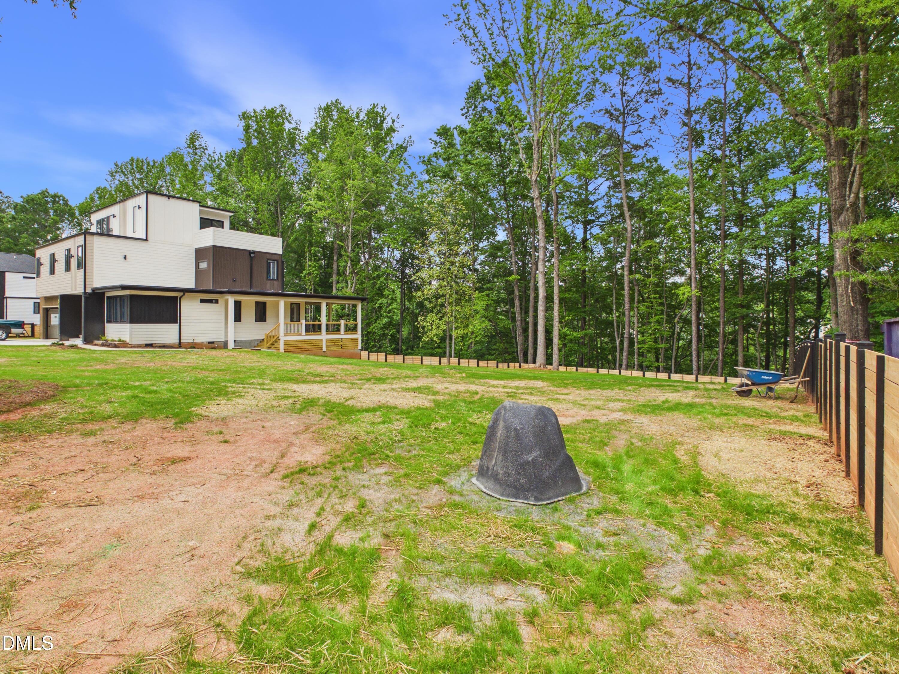 6925 Buckhorn-Duncan Road Holly Springs, NC 27540 - Photo 38 of 43 a view of a house with swimming pool and a small yard