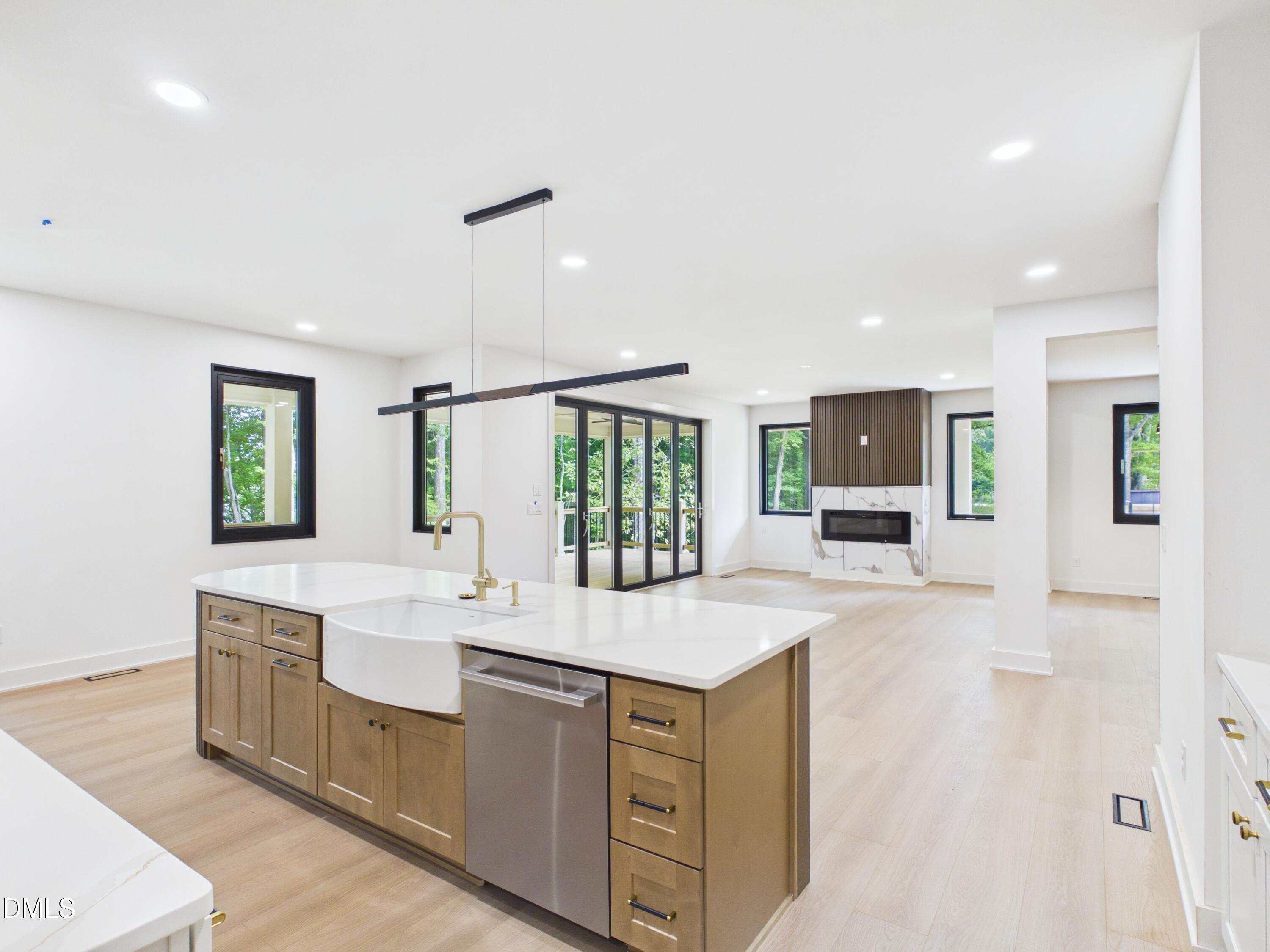 6925 Buckhorn-Duncan Road Holly Springs, NC 27540 - Photo 5 of 43 a large white kitchen with a sink and a large window