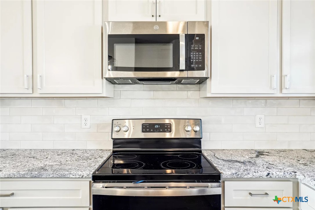 289 Star Grass, Unit 3 Spring Branch, TX 78070 - Photo 9 of 40 a stove top oven sitting inside of a kitchen