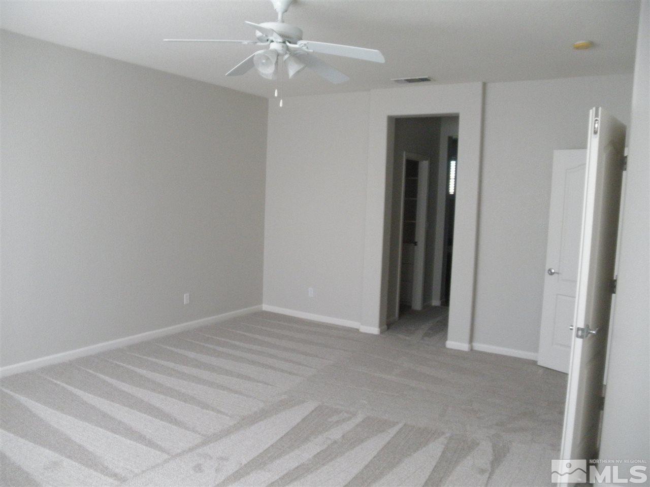 10550 Autumn Walk Court Reno, NV 89521 - Photo 11 of 15 a view of an empty room with a ceiling fan