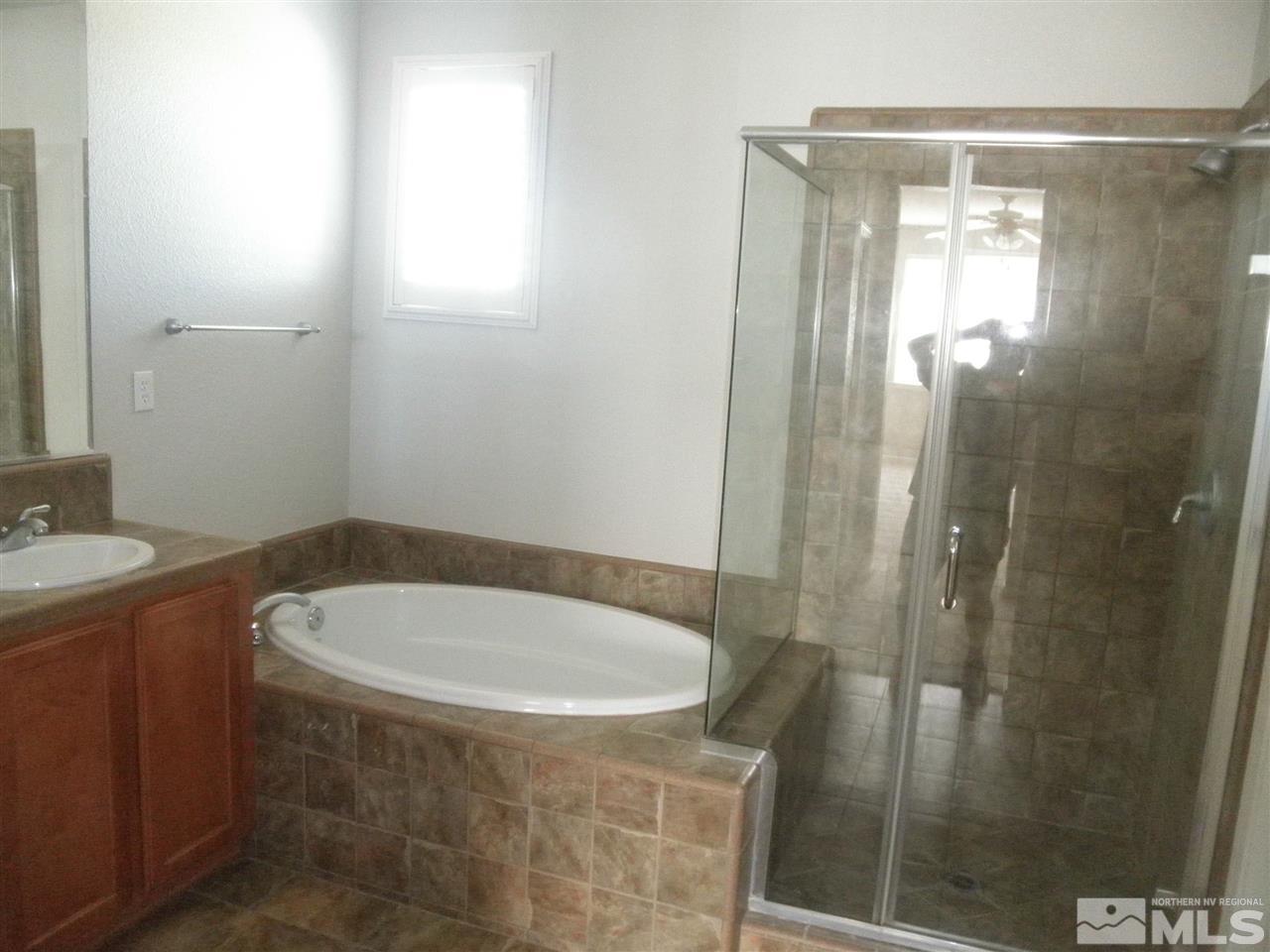 10550 Autumn Walk Court Reno, NV 89521 - Photo 12 of 15 a bathroom with a tub a sink and a shower