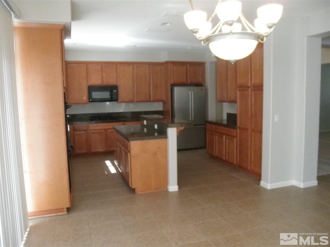 10550 Autumn Walk Court Reno, NV 89521 - Photo 4 of 15 a kitchen with stainless steel appliances granite countertop a refrigerator and a sink