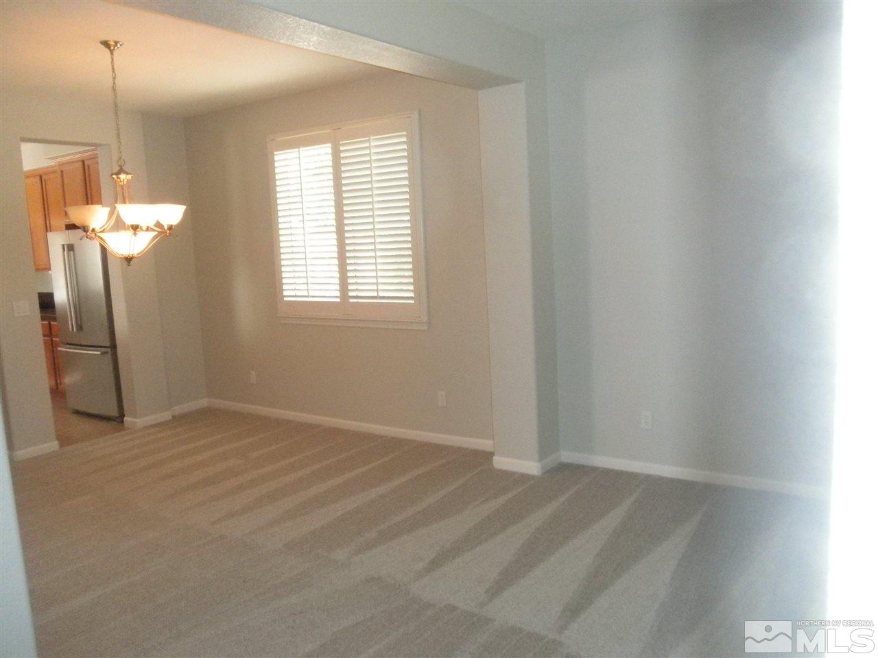 10550 Autumn Walk Court Reno, NV 89521 - Photo 6 of 15 a view of empty room with wooden floor and fan