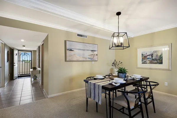 a view of a dining room with furniture and chandelier