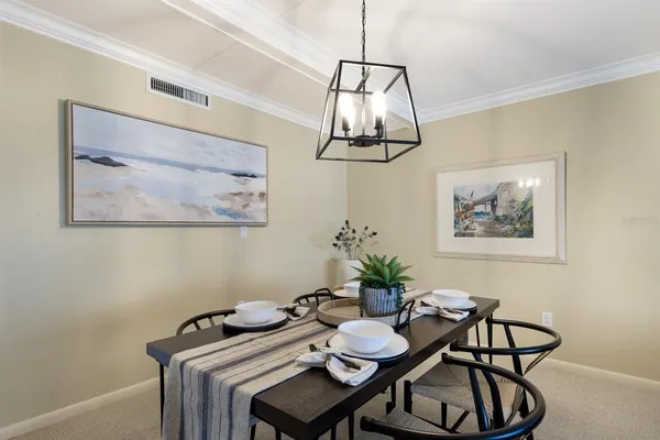 a view of a dining room with furniture and chandelier