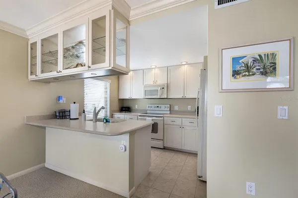 a kitchen with a sink cabinets and window