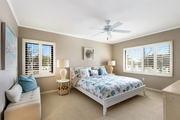 a bedroom with a bed a couch and a larger window