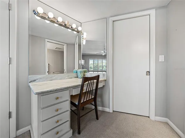 a bathroom with a granite countertop sink a mirror and a shower