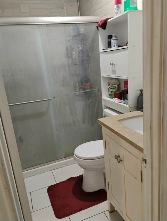 763 Frontier Street Bowie, TX 76230 - Photo 19 of 28 a bathroom with a sink a toilet and shower