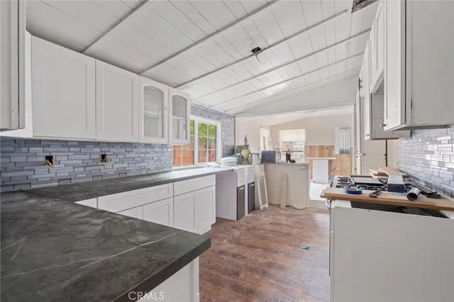 a kitchen with refrigerator and cabinets