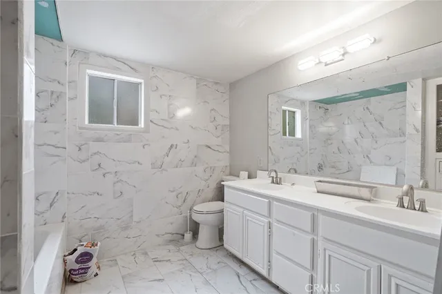 a bathroom with a sink toilet and mirror