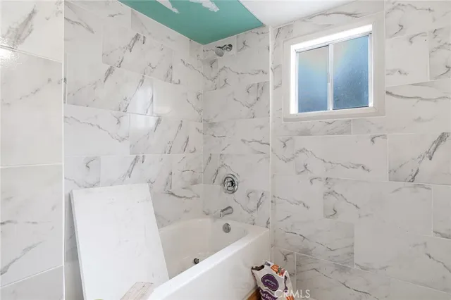 a bathroom with a bathtub and shower