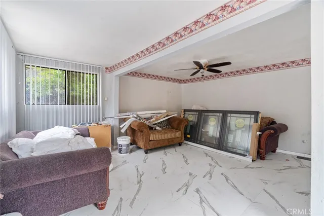 a bedroom with furniture and a large window