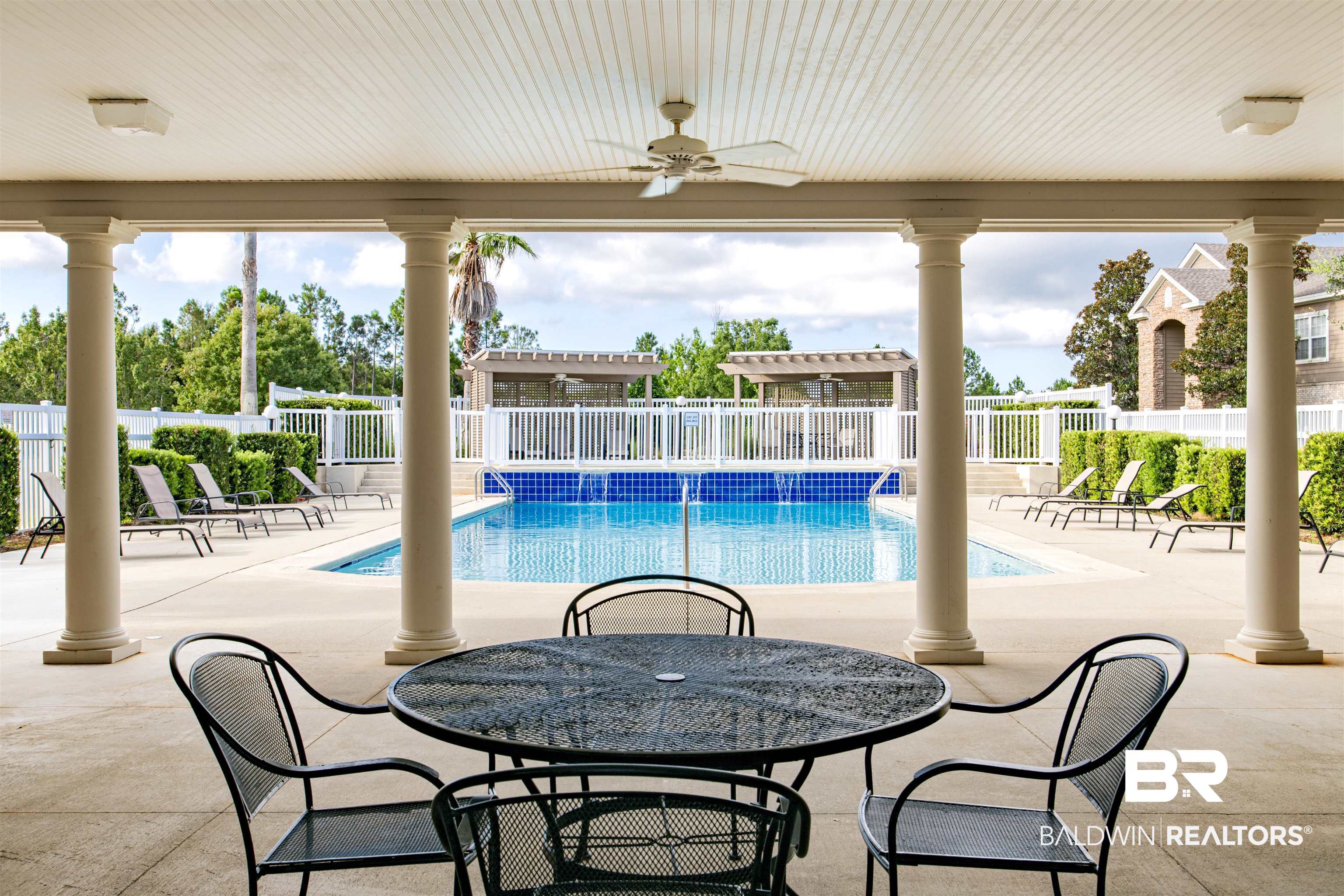 450 Park Avenue, Unit 202 Foley, AL 36535 - Photo 16 of 18 Community pool featuring a patio, ceiling fan, and outdoor dining space