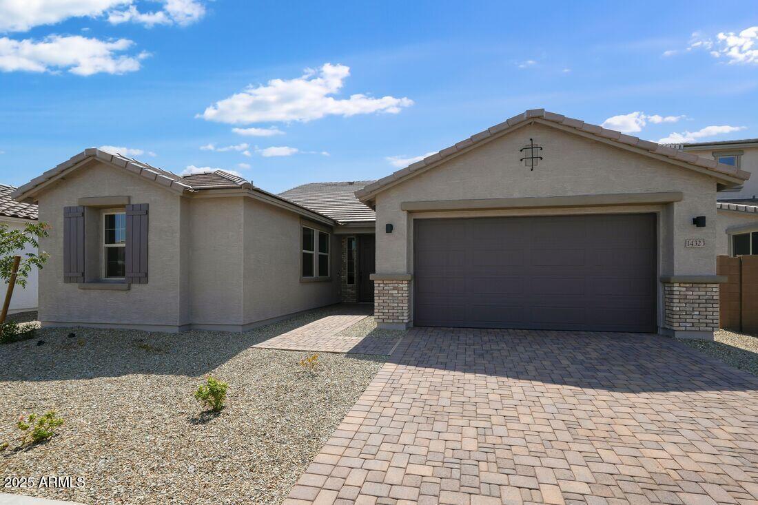 14323 West Alameda Road Surprise, AZ 85387 - Photo 1 of 56 a front view of a house with a yard