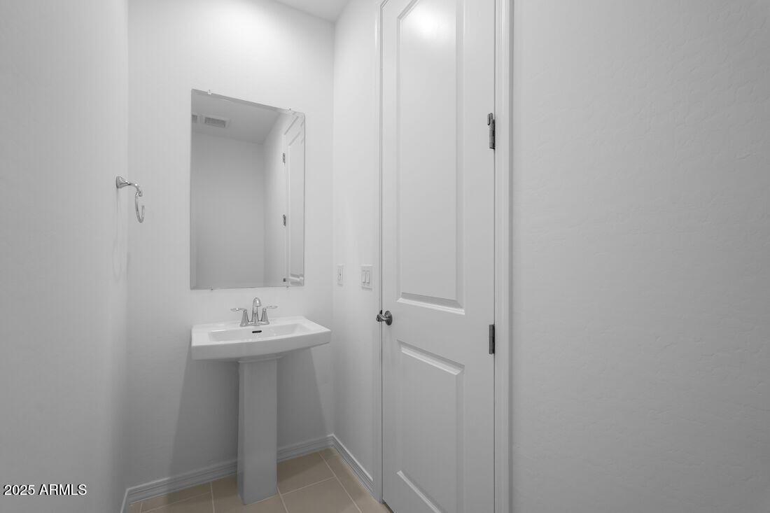 14323 West Alameda Road Surprise, AZ 85387 - Photo 13 of 56 a bathroom with a sink and mirror