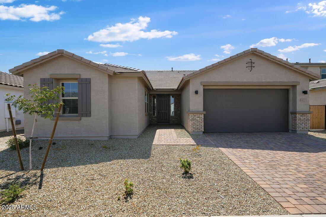 14323 West Alameda Road Surprise, AZ 85387 - Photo 2 of 56 a front view of a house with garden