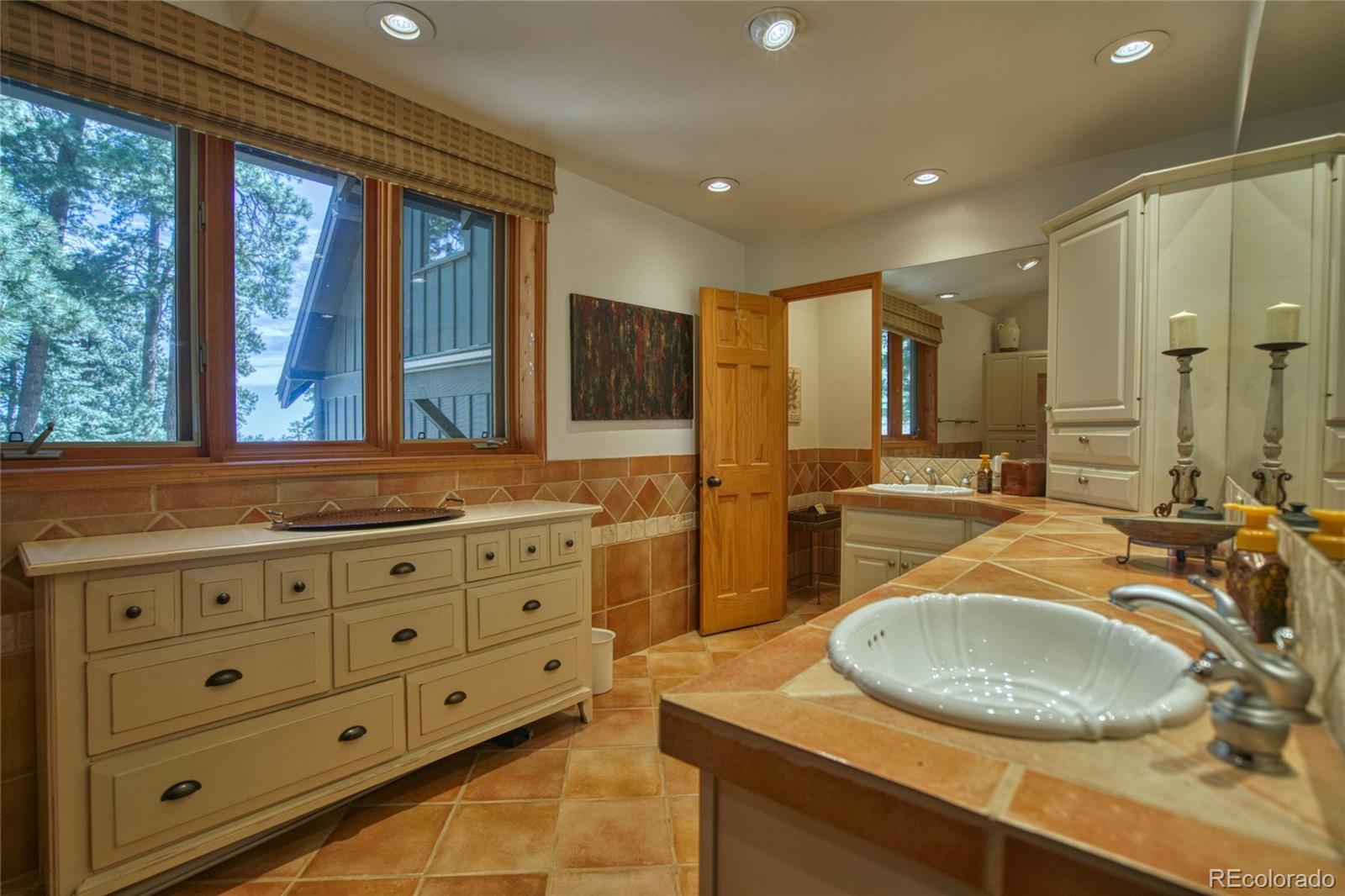 8555 Cuerna Verde Road Rye, CO 81069 - Photo 13 of 35 a bathroom with a granite countertop sink mirror and window