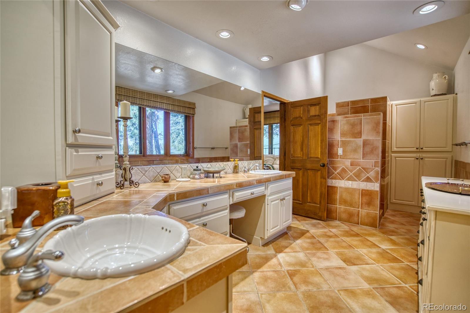 8555 Cuerna Verde Road Rye, CO 81069 - Photo 14 of 35 a bathroom with 2 sink tub shower and a mirror