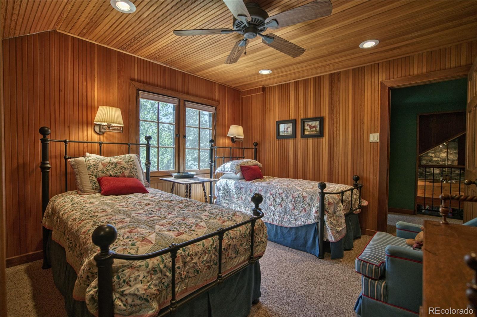 8555 Cuerna Verde Road Rye, CO 81069 - Photo 18 of 35 a bedroom with two beds and a chandelier