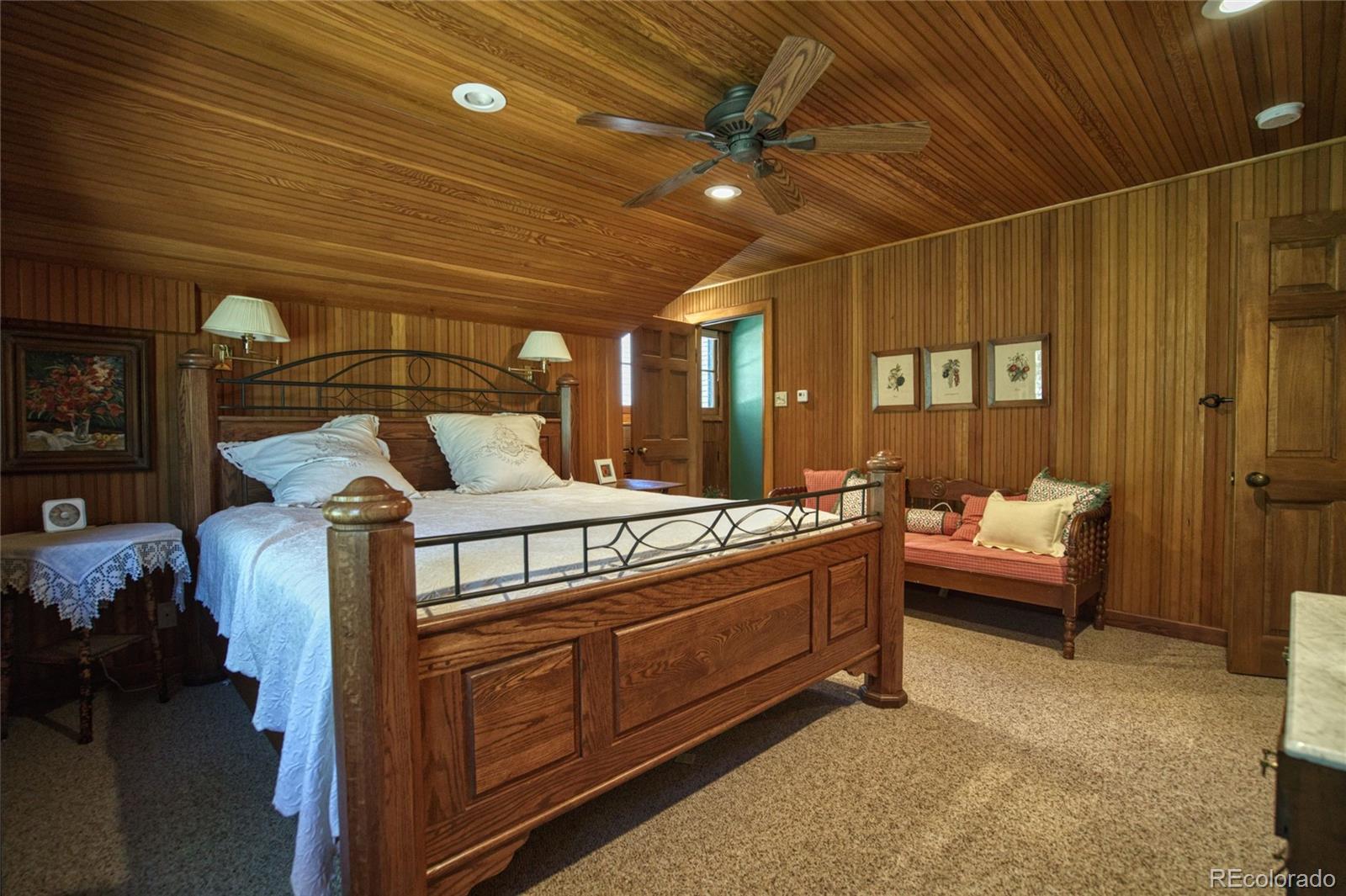 8555 Cuerna Verde Road Rye, CO 81069 - Photo 19 of 35 a bedroom with furniture and a chandelier