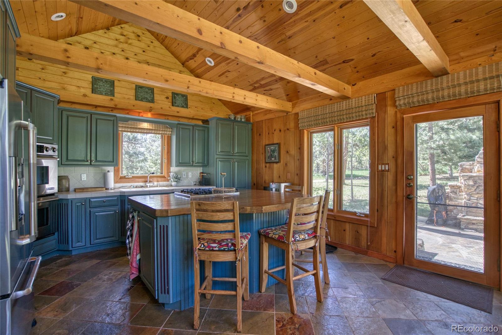 8555 Cuerna Verde Road Rye, CO 81069 - Photo 2 of 35 a dining hall with stainless steel appliances granite countertop a table and chairs