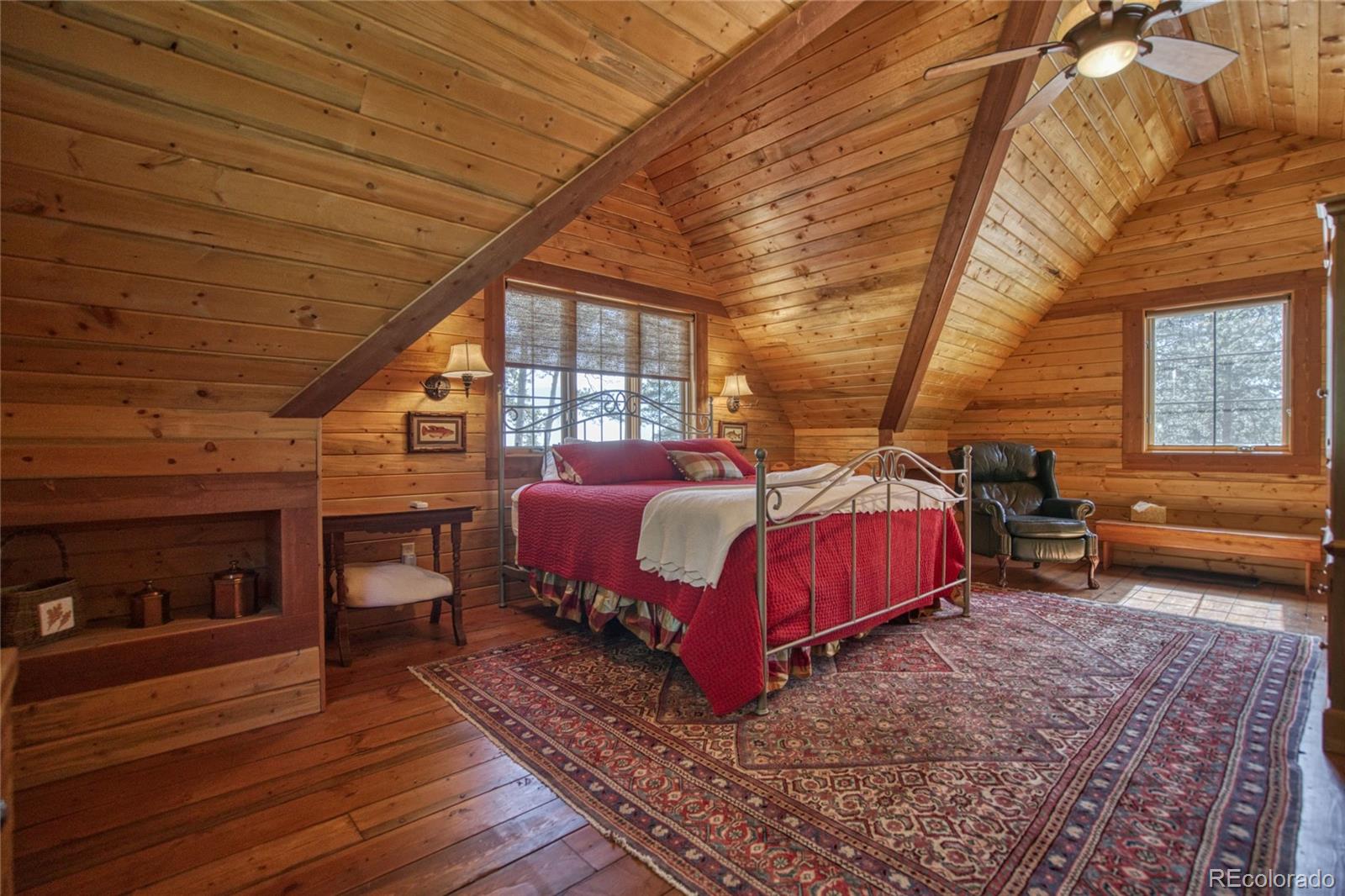 8555 Cuerna Verde Road Rye, CO 81069 - Photo 22 of 35 a bedroom with a bed and wooden floor