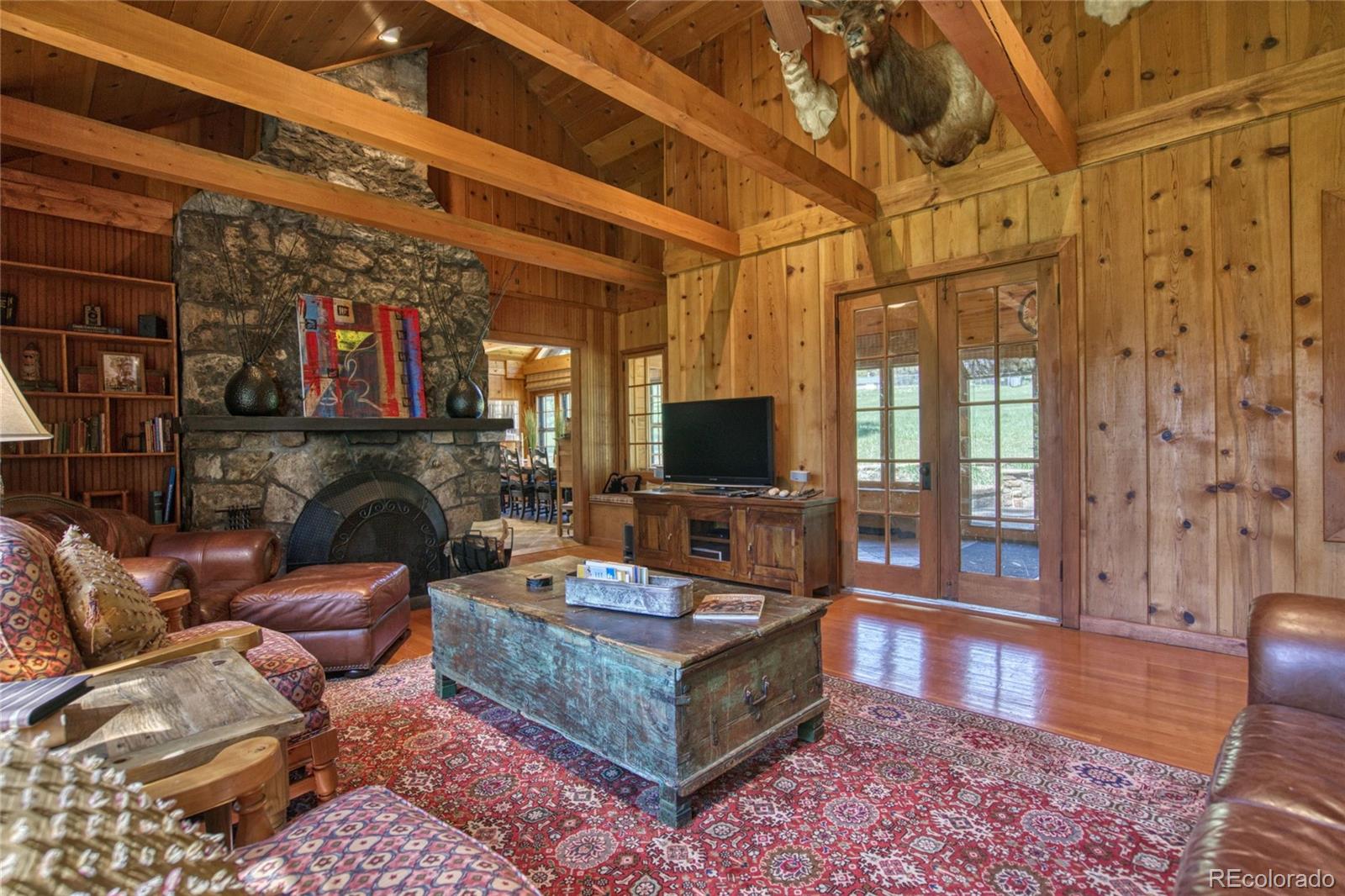 8555 Cuerna Verde Road Rye, CO 81069 - Photo 10 of 35 a living room with furniture a flat screen tv and a fireplace