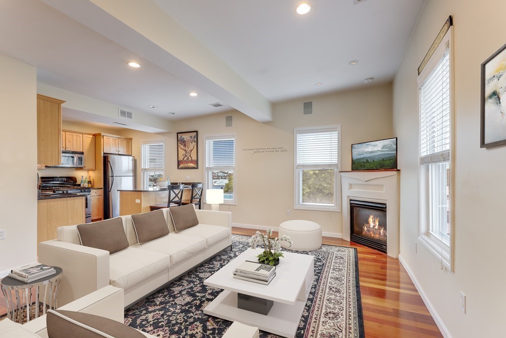 a living room with furniture fireplace and rug