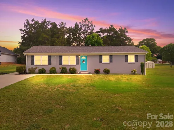 a front view of house with yard and outdoor seating
