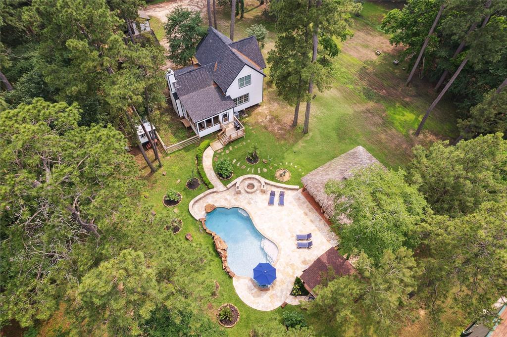 an aerial view of a house with a swimming pool and outdoor space