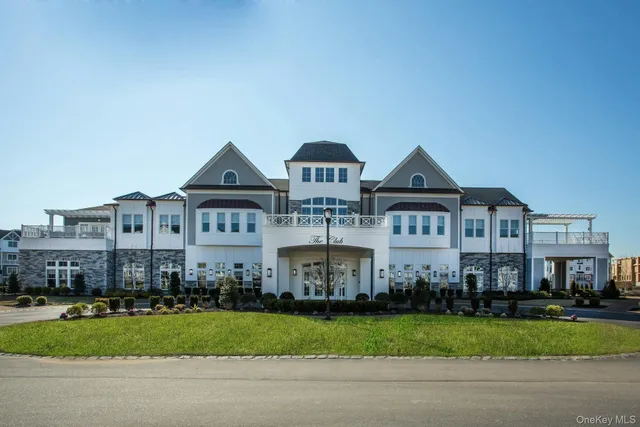 a front view of a house with a yard and a garage