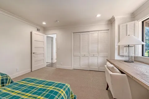 a bedroom with a bed and a cabinets