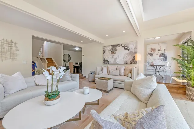 a living room with furniture and kitchen view