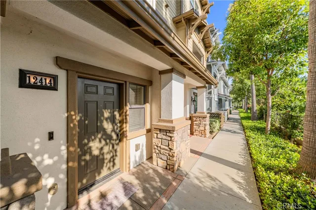 a view of house with patio outdoor seating and plants