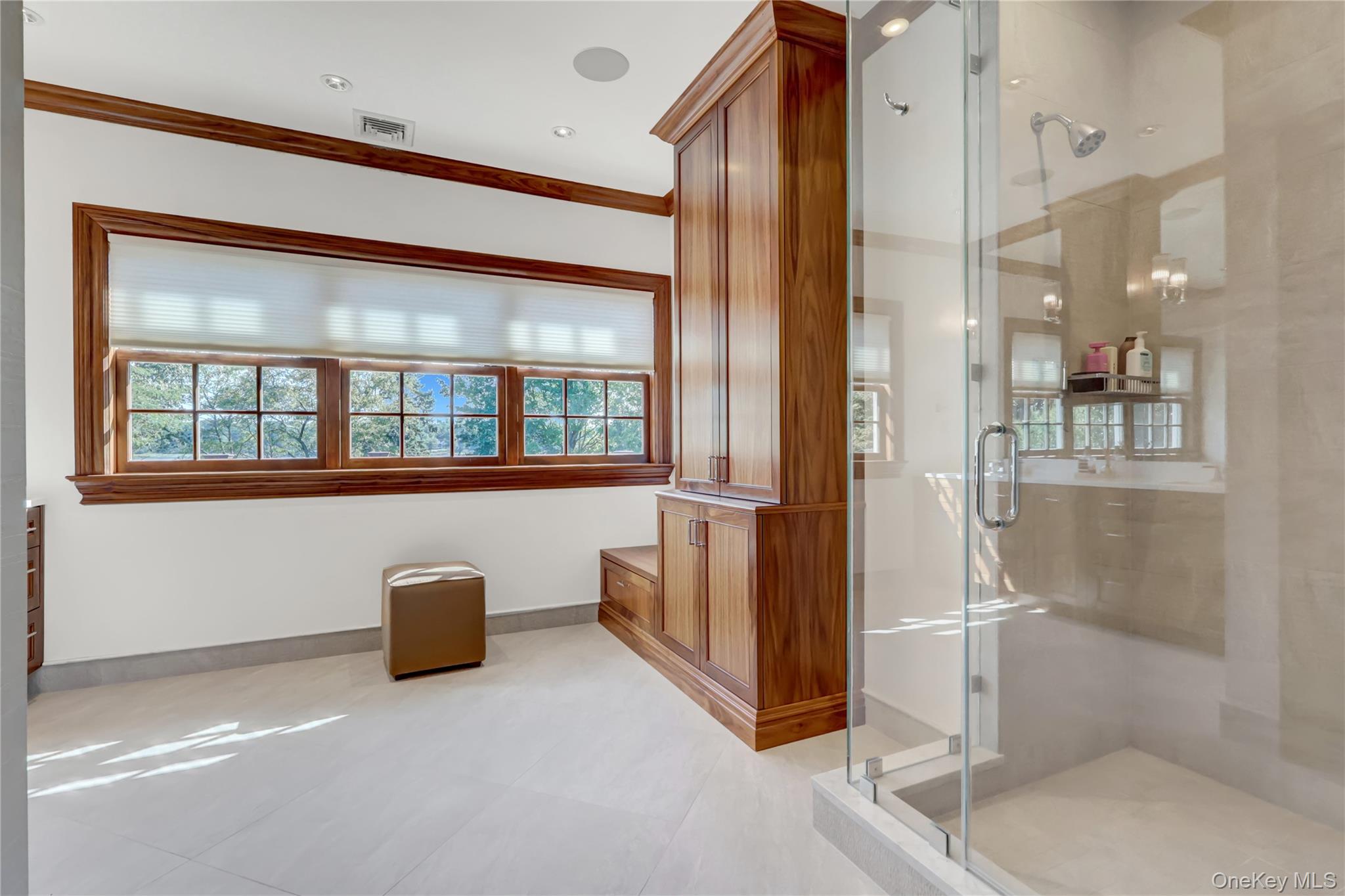 63 Dyke Road Setauket, NY 11733 - Photo 23 of 49 Bathroom with a stall shower, ornamental molding, and light tile patterned floors