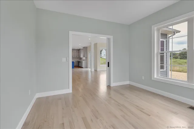 wooden floor in an empty room with a window